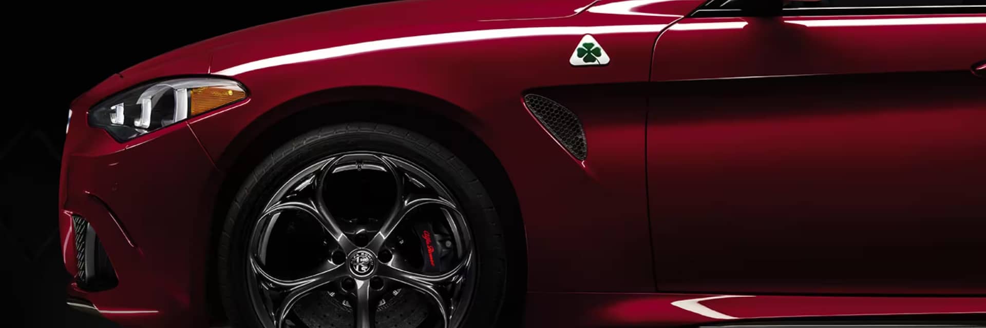 Side close up view of a red Alfa Romeo Giulia Quadrifoglio