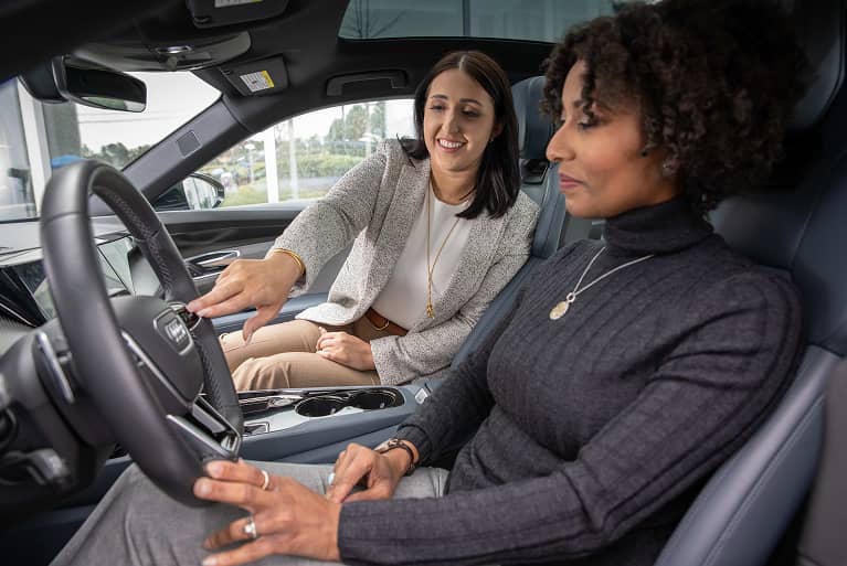 Two women looking at the interior of an Audi