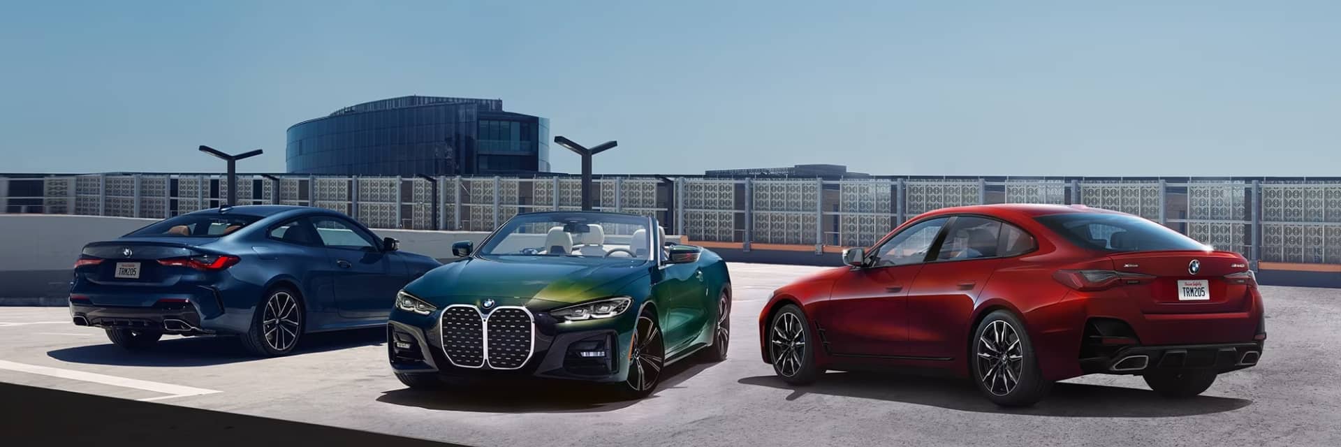 BMW Models Parked On A Rooftop Parking Garage In The Sun