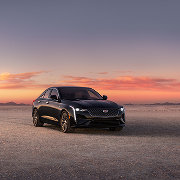 Three Quarters Front View of a Black 2025 CT4 Parked in the Open Desert 