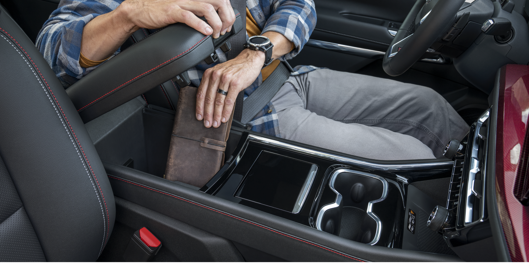 Man placing items in middle compartment. 