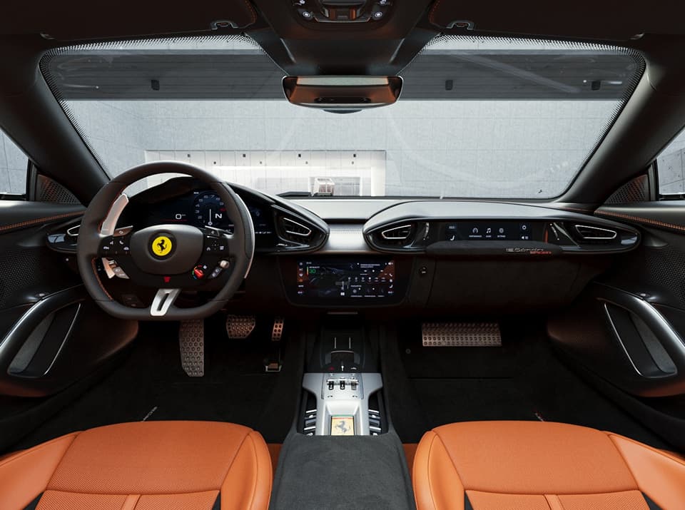 Ferrari interior with tan leather seats, a flat-bottom steering wheel, digital instrument cluster, and central touchscreen display.