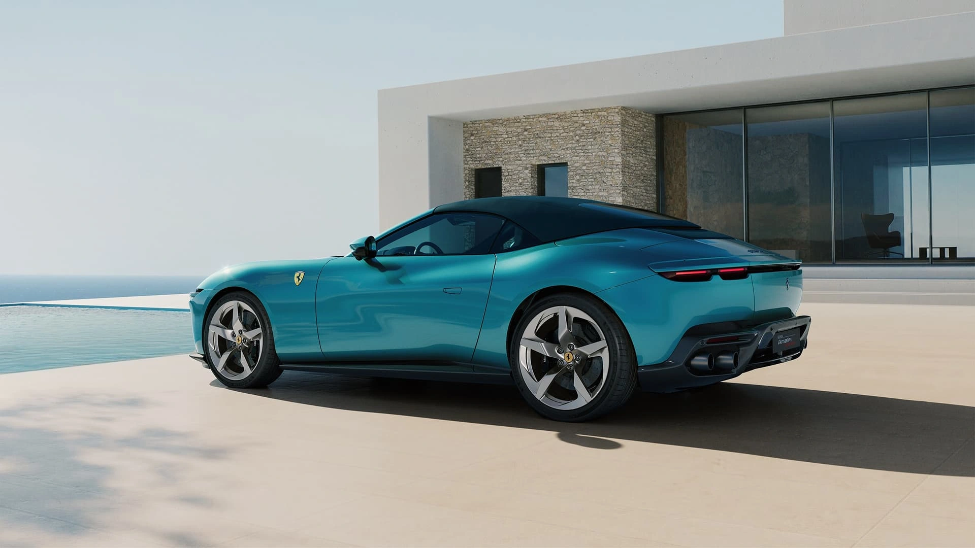 Ferrari Amalfi Spider in teal, three-quarter rear view with soft top up, parked beside a pool