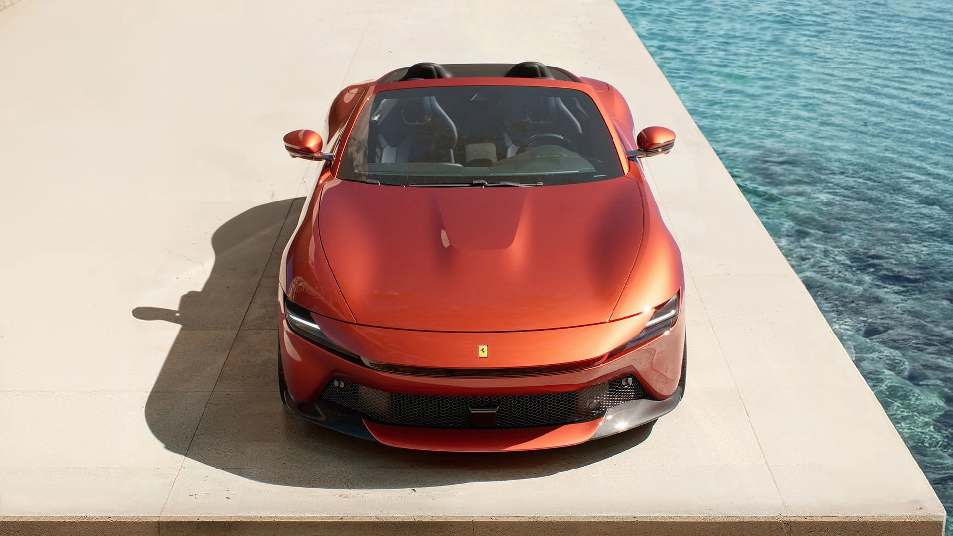 Ferrari Amalfi Spider in red, overhead front view, parked on a seaside terrace