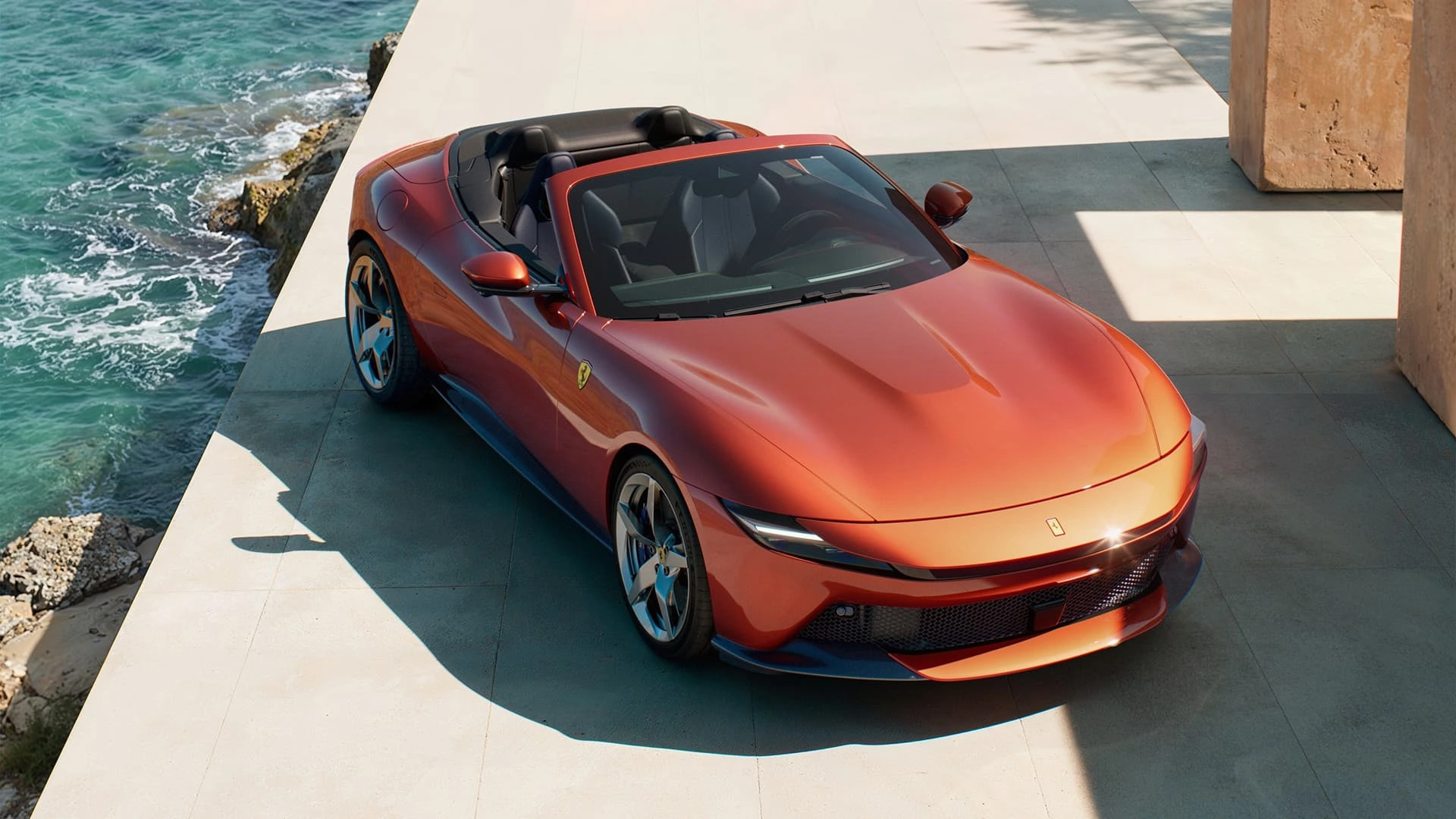 Ferrari Amalfi Spider in red, three-quarter front elevated view, parked on a coastal terrace