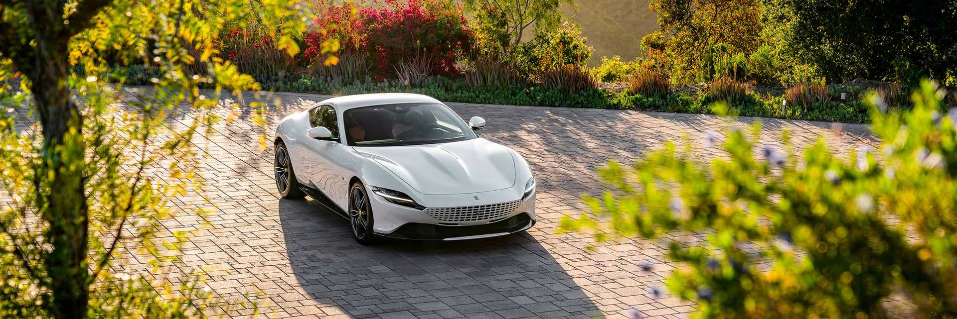 A white Ferrari parked at an angle
