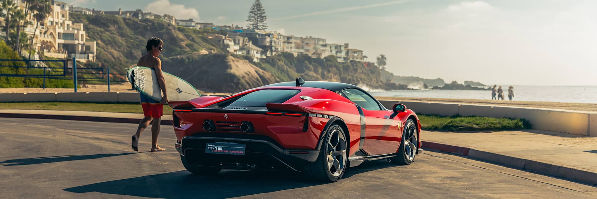 A red Ferrari parked at the beach