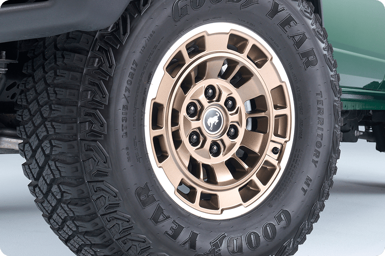 Close-up of a bronze Bronco alloy wheel with Goodyear off-road tire.