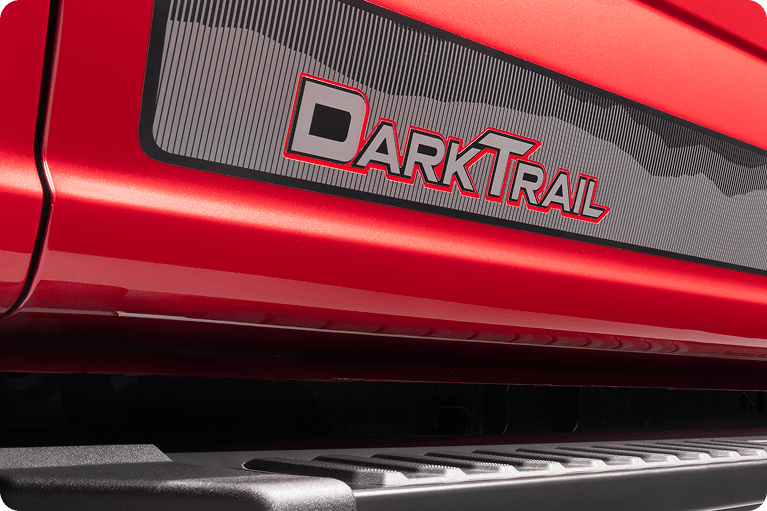 Close-up of the Dark Trail side graphic on a red Ford F-150.