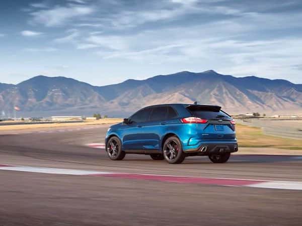 Blue Ford Edge ST driving on a test track