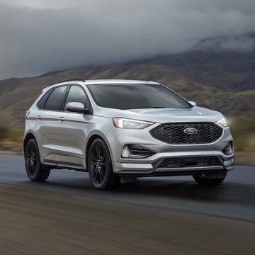 A Ford Edge driving on a stormy mountain road