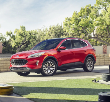 Red Ford Escape parked in a park