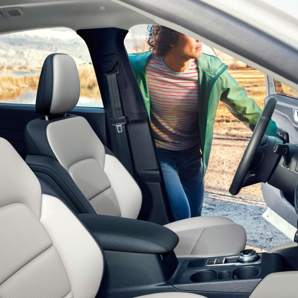 Person Getting into Ford Escape with White and Black Interior