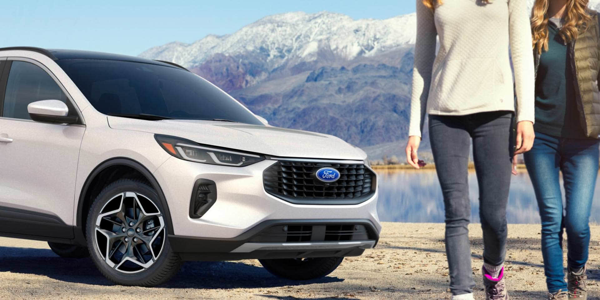 People walking in front of a parked Ford Escape.