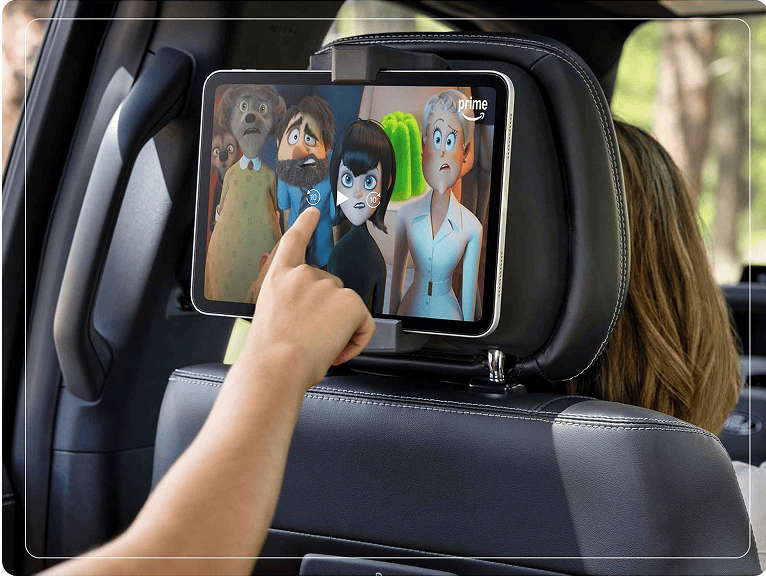 Passenger using a tablet in the available second-row digital device holder in a 2025 Ford Expedition® SUV