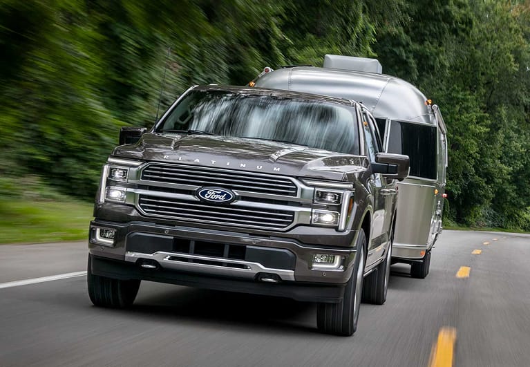 2025 Ford F-150® Platinum® pickup pulling a camper