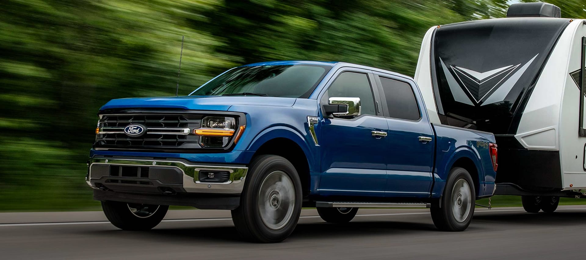 2025 Ford F-150® pickup towing camper. 