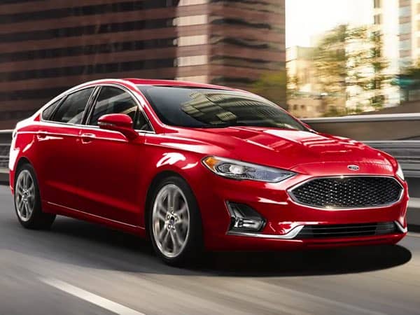 Red Ford Fusion Hybrid driving