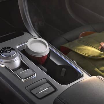 Interior shot of the Ford Fusion Hybrid rotary gear shift dial and cupholders