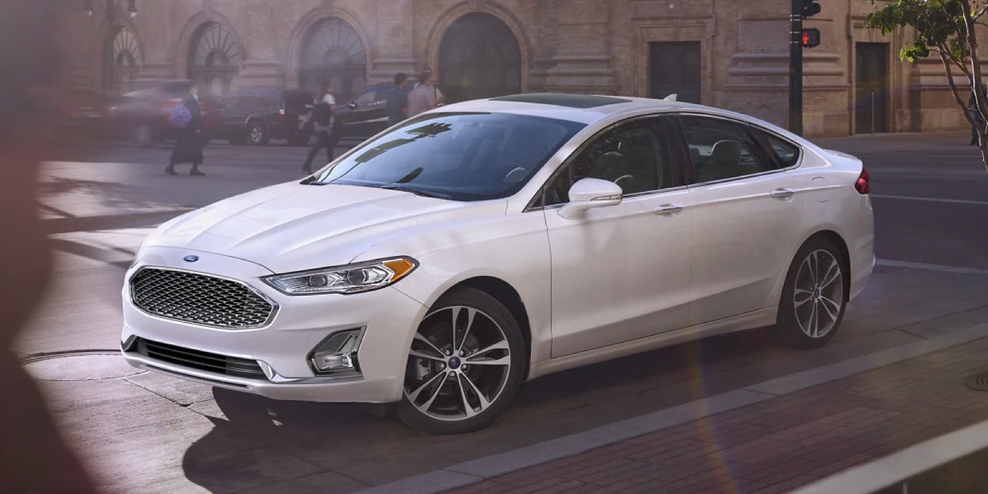 2020 Ford Fusion in Oxford White driving in the city