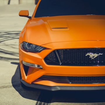 Front grille & headlight of 2021 Ford Mustang in Twister Orange