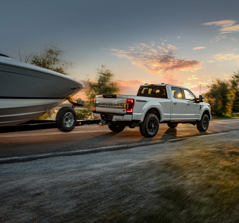Super Duty Driving down road hauling boat
