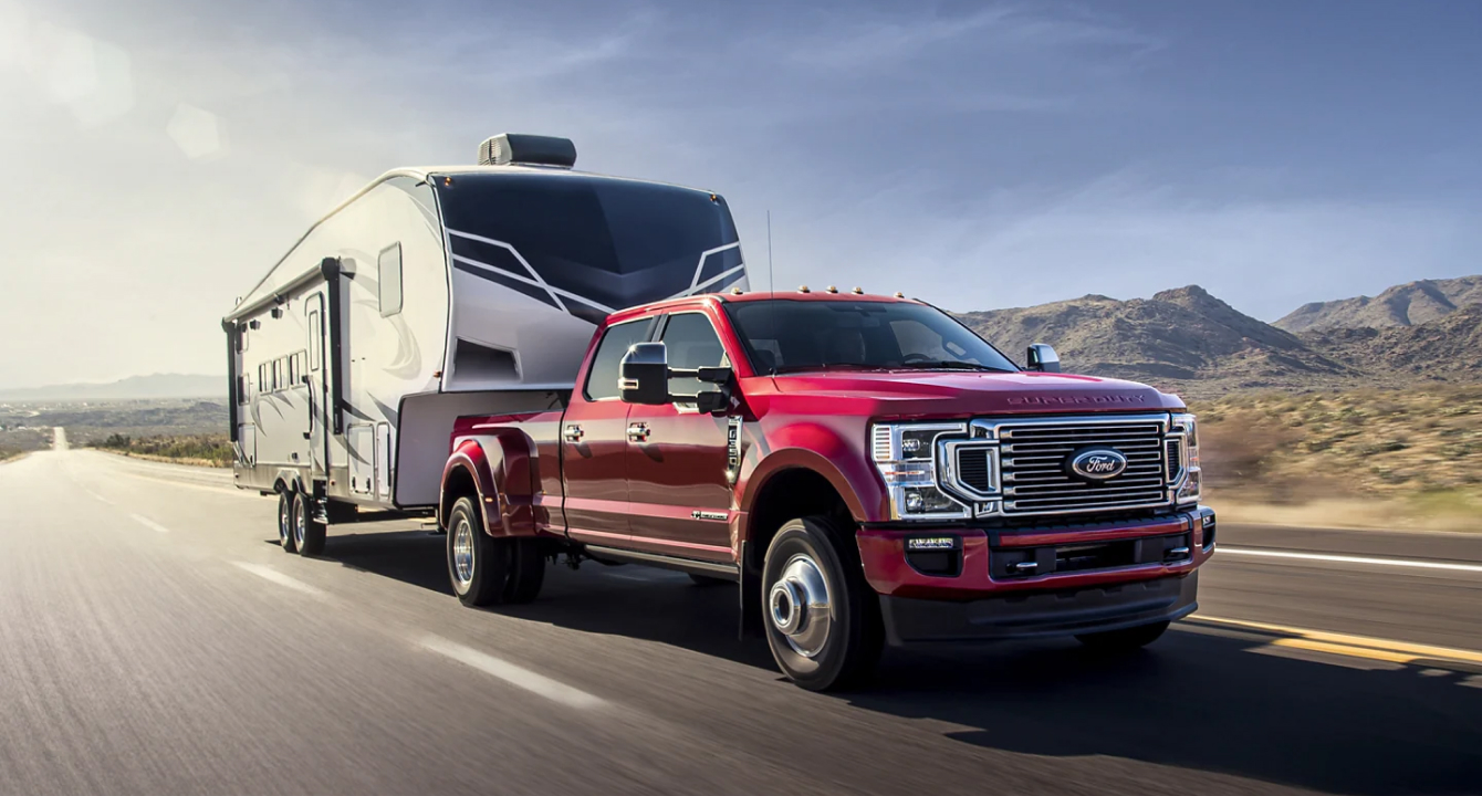 Super duty driving down road with trailer