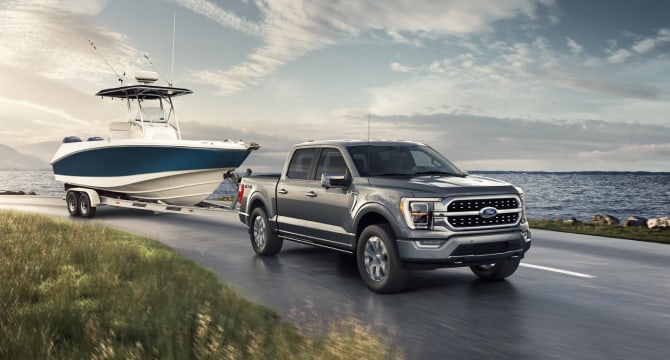 2022 Ford F-150 towing a boat near a lake