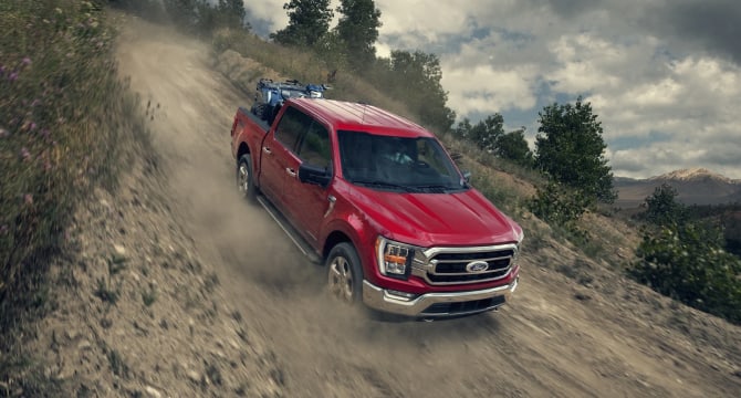 2022 Ford F-150 driving downhill on a dirt road 