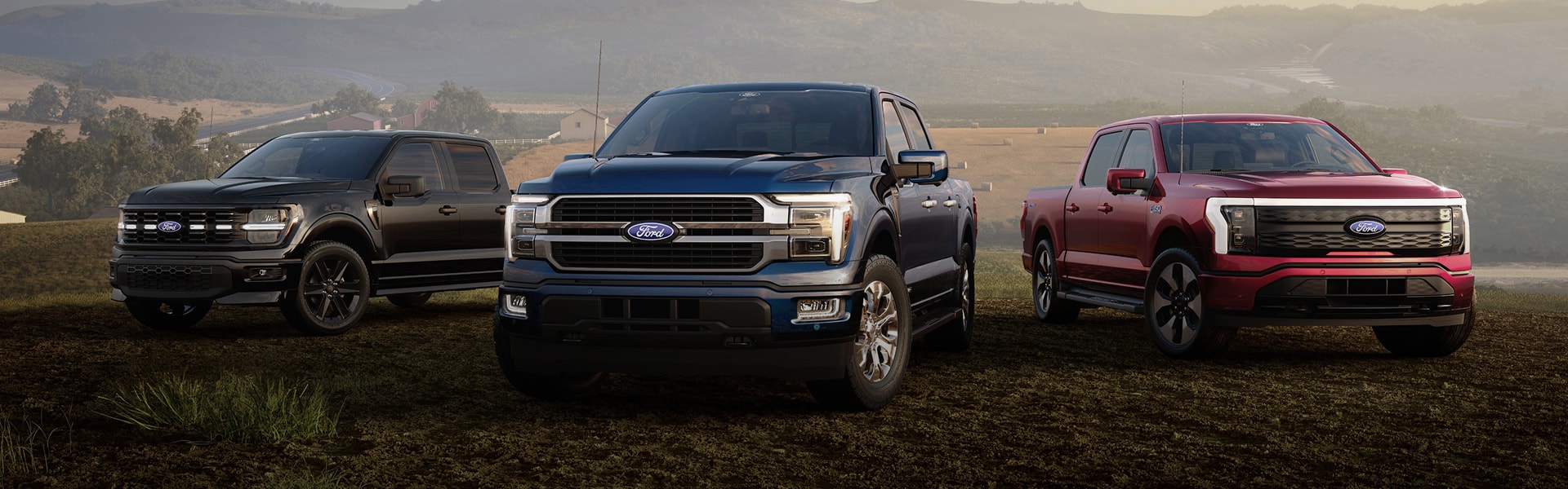 Multiple Ford pickup trucks showcased in a scenic, rural outdoor setting.