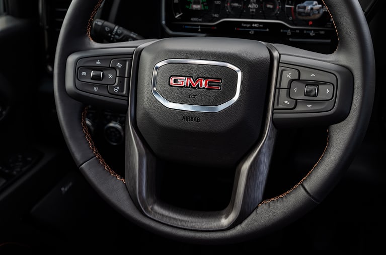 Close up of a GMC steering wheel inside of a vehicle