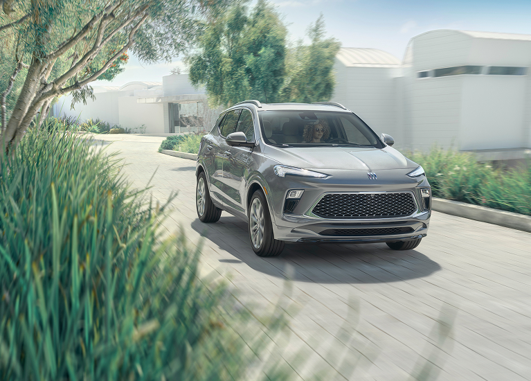 An image of a Buick SUV traveling on a driveway