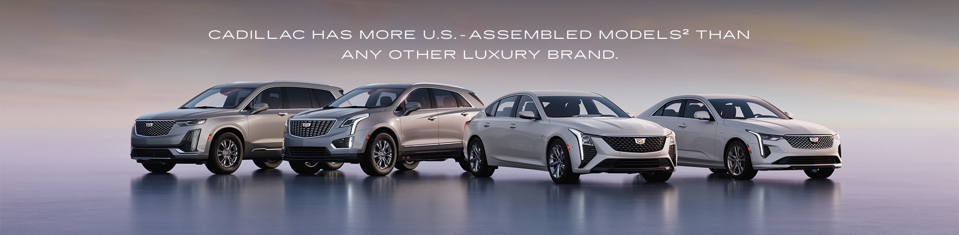 Lineup of Cadillac vehicles at sunset