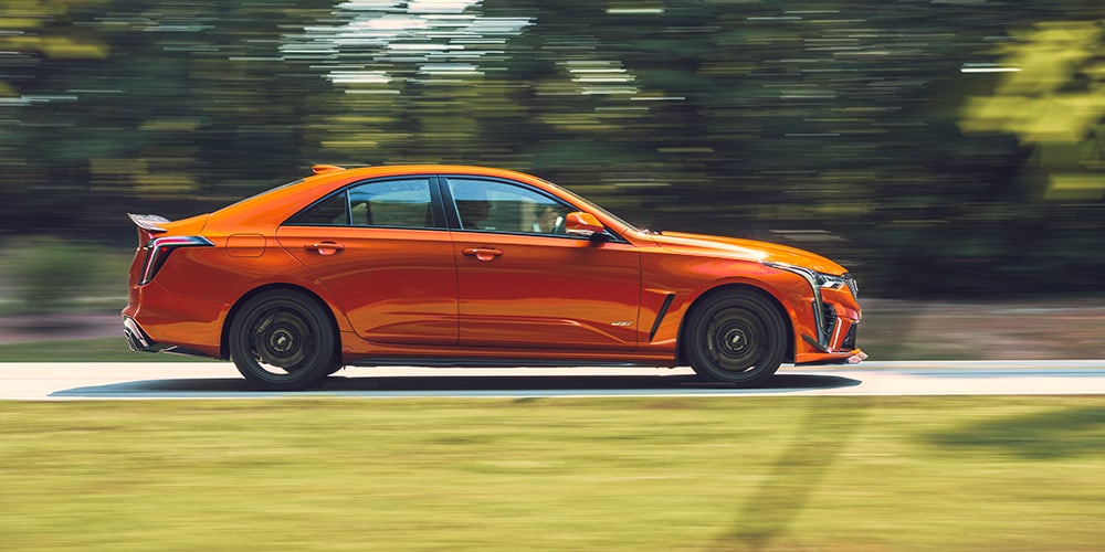 2023 Cadillac CT4-V driving past trees