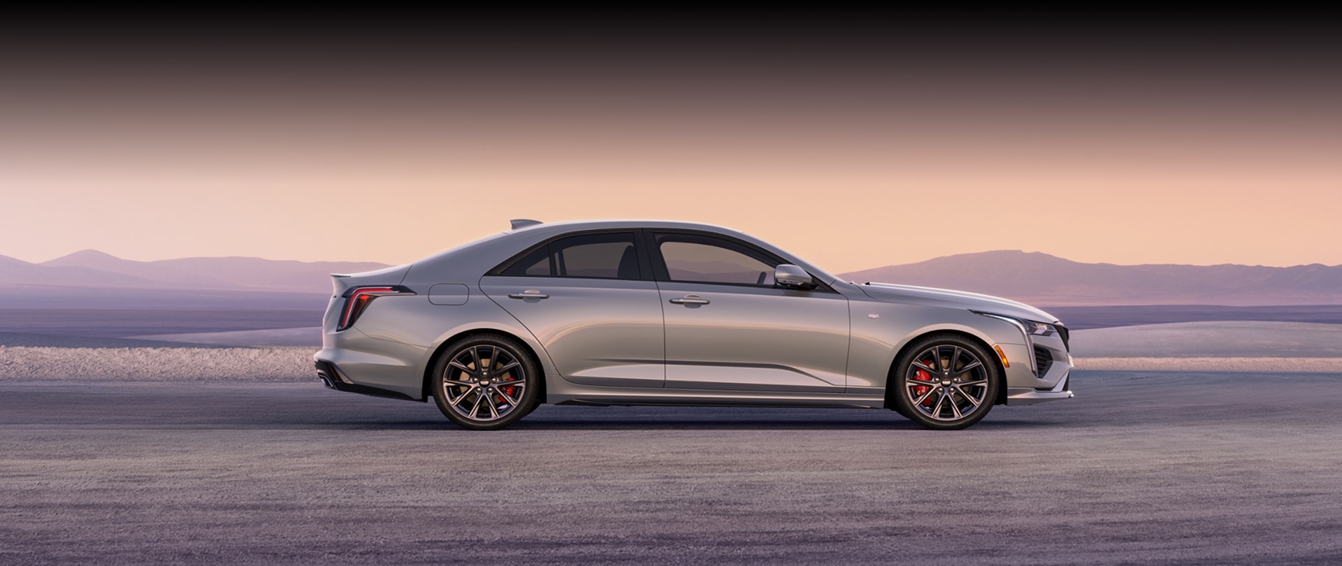 Side Profile View of a Silver 2026 CT4 Parked in the Open Desert