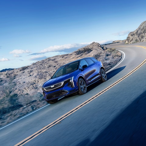 Cadillac OPTIQ-V driving on a mountain highway