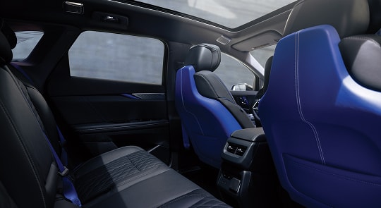 Back Seat View of the 2026 OPTIQ-V Blue Front Seats, Sun Roof, and Interior