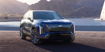 Three-quarters View of the 2026 Cadillac VISTIQ Parked Near a Lake Surrounded by Mountains