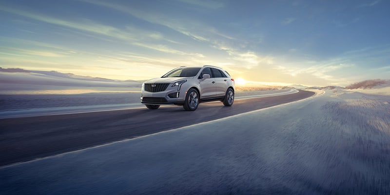 2023 Cadillac XT5 driving on a snowy road