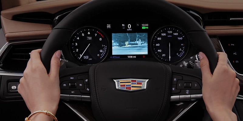 drivers hands on the steering wheel