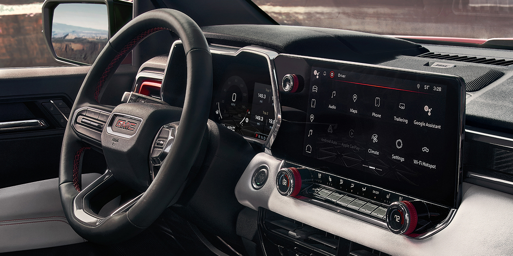 The Interior Dashboard of a GMC Canyon AT4X With a Steering Wheel Digital Cluster and Large Infotainment Touchscreen