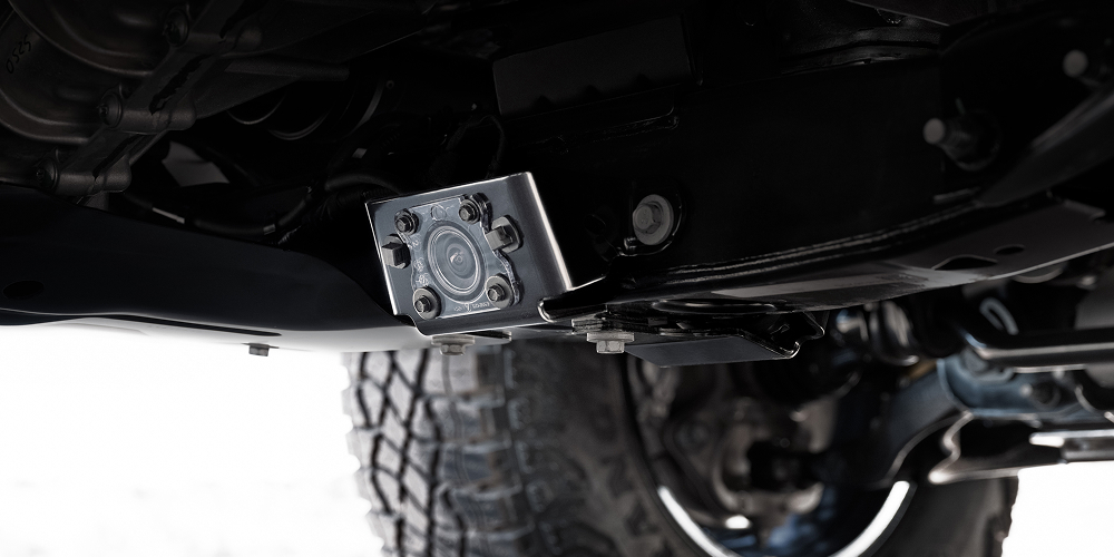 A Close-up View of an Underbody Camera Mounted on the Chassis of a GMC Canyon AT4X Truck
