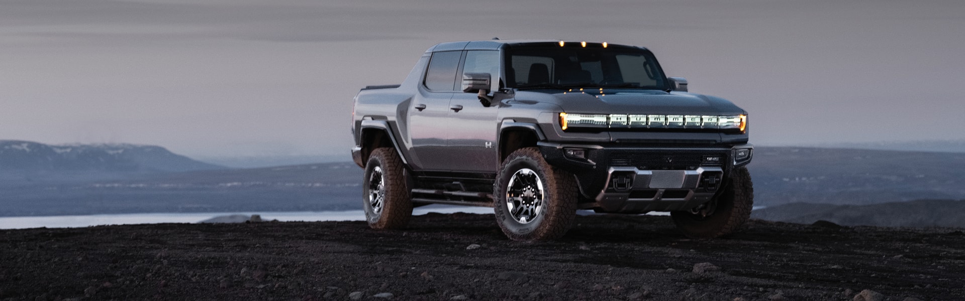 GMC Hummer EV Pickup parked near a lake