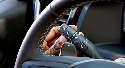 driver's hand on a turn signal