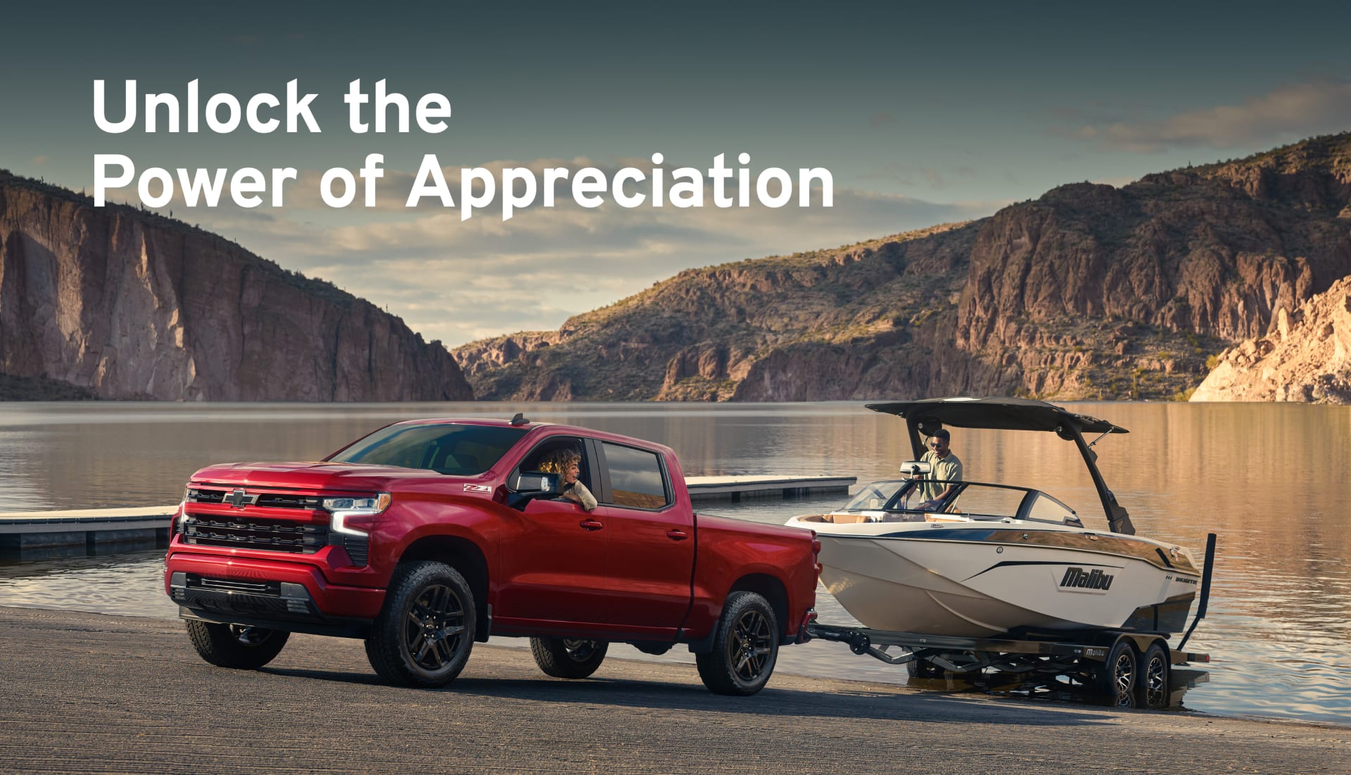 Chevy Silverado launching a boat in a mountain lake