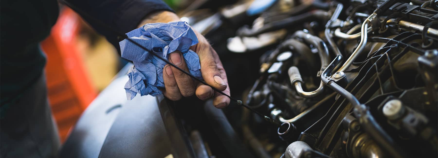 Car service mechanic working on automobile engine repair
