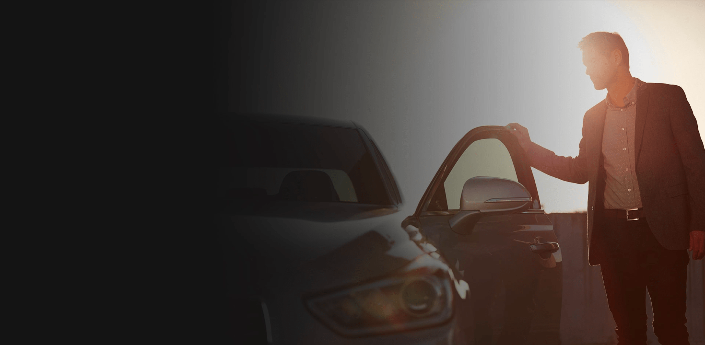 A man opens the driver's side door of a Genesis vehicle