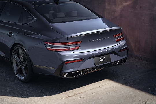 3/4 rear driver side view of exterior, taillight and trunk detail on Genesis G80 in Ceres Blue