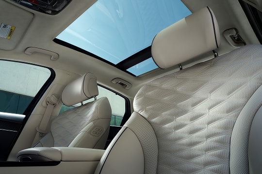 Interior view of sunroof and front seats from driver seat pov inside the Genesis G80