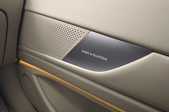 Close up of Bang & Olufsen speaker system in beige interior door of Genesis G80